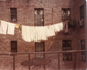 Anna's laundry strung on the clothesline attached by pulleys to the tenement behind ours. 